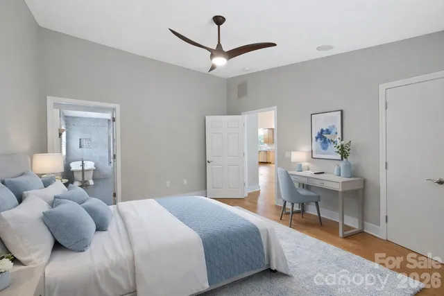 a bedroom with a bed and a table chair