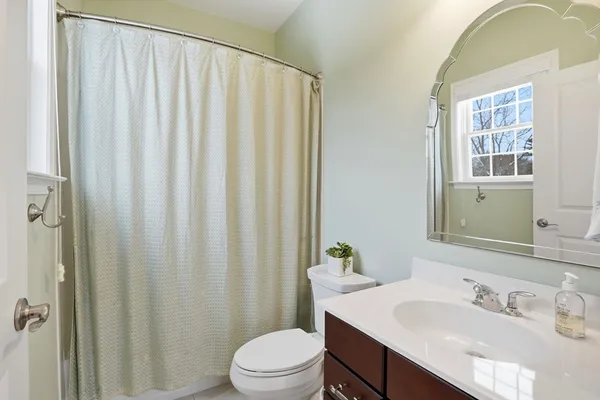 a bedroom with bed and a large window