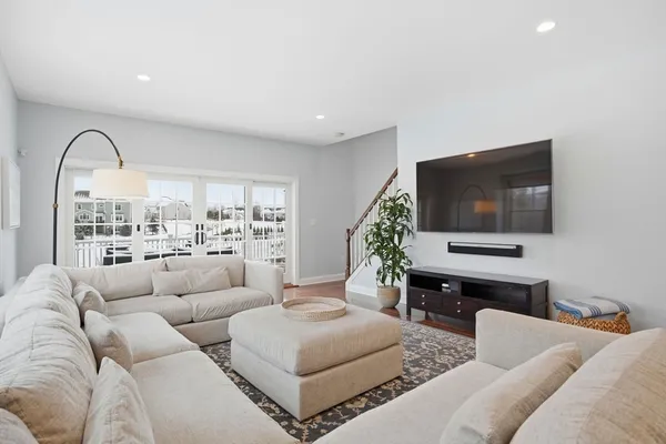 a large kitchen with white cabinets and stainless steel appliances