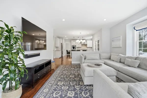 a kitchen with stainless steel appliances granite countertop a sink a stove cabinets counter space and a window