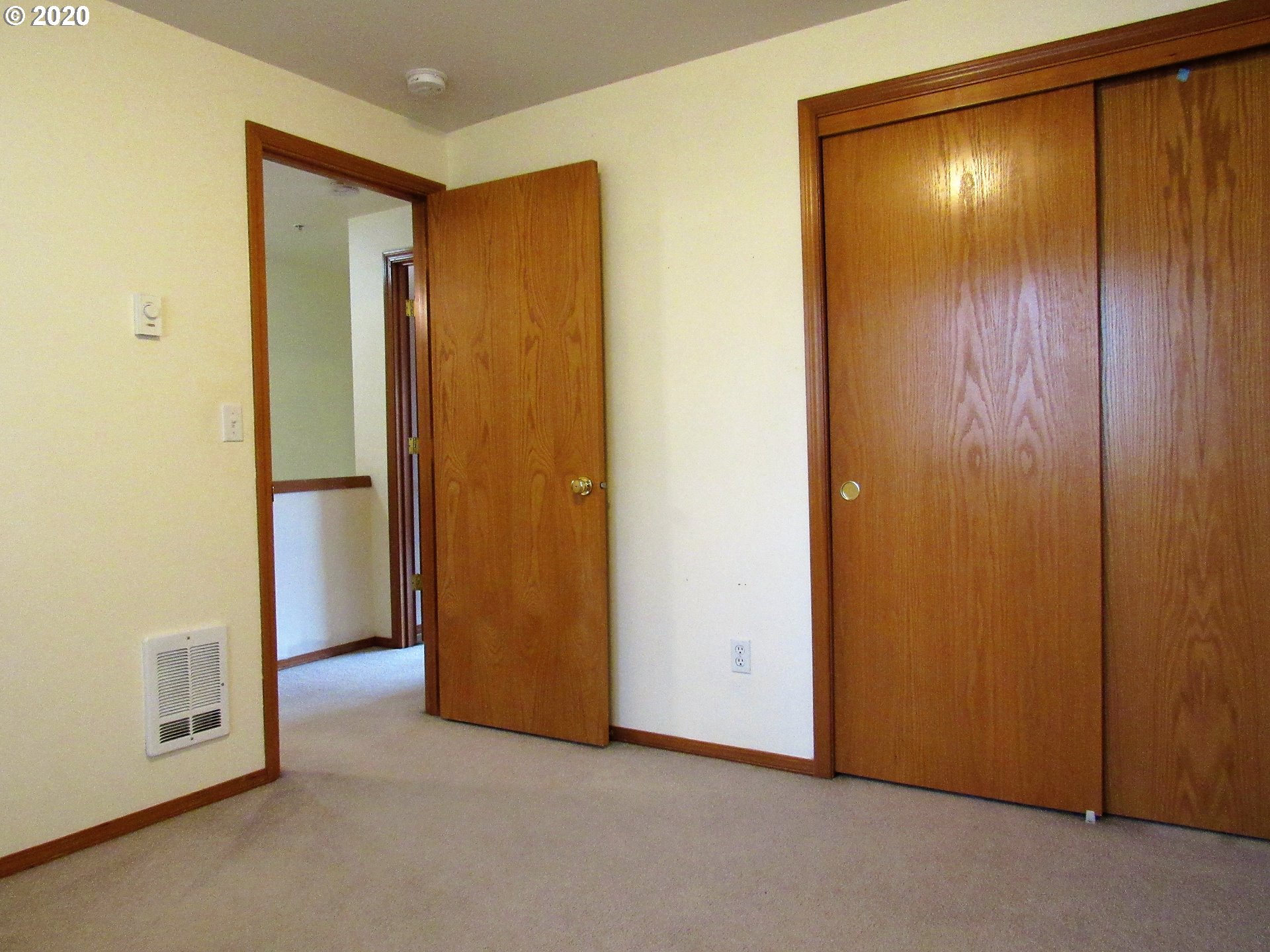 1244 Southwest 160th Avenue, Unit 101 Beaverton, OR 97006 - Photo 18 of 24 a view of an empty room with closet and wooden floor