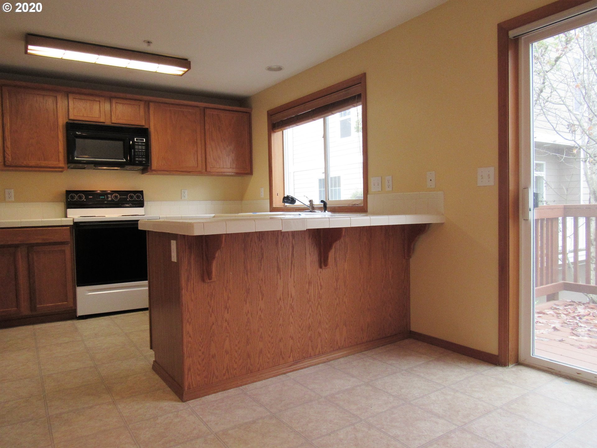 1244 Southwest 160th Avenue, Unit 101 Beaverton, OR 97006 - Photo 3 of 24 a kitchen with stainless steel appliances a sink stove and microwave