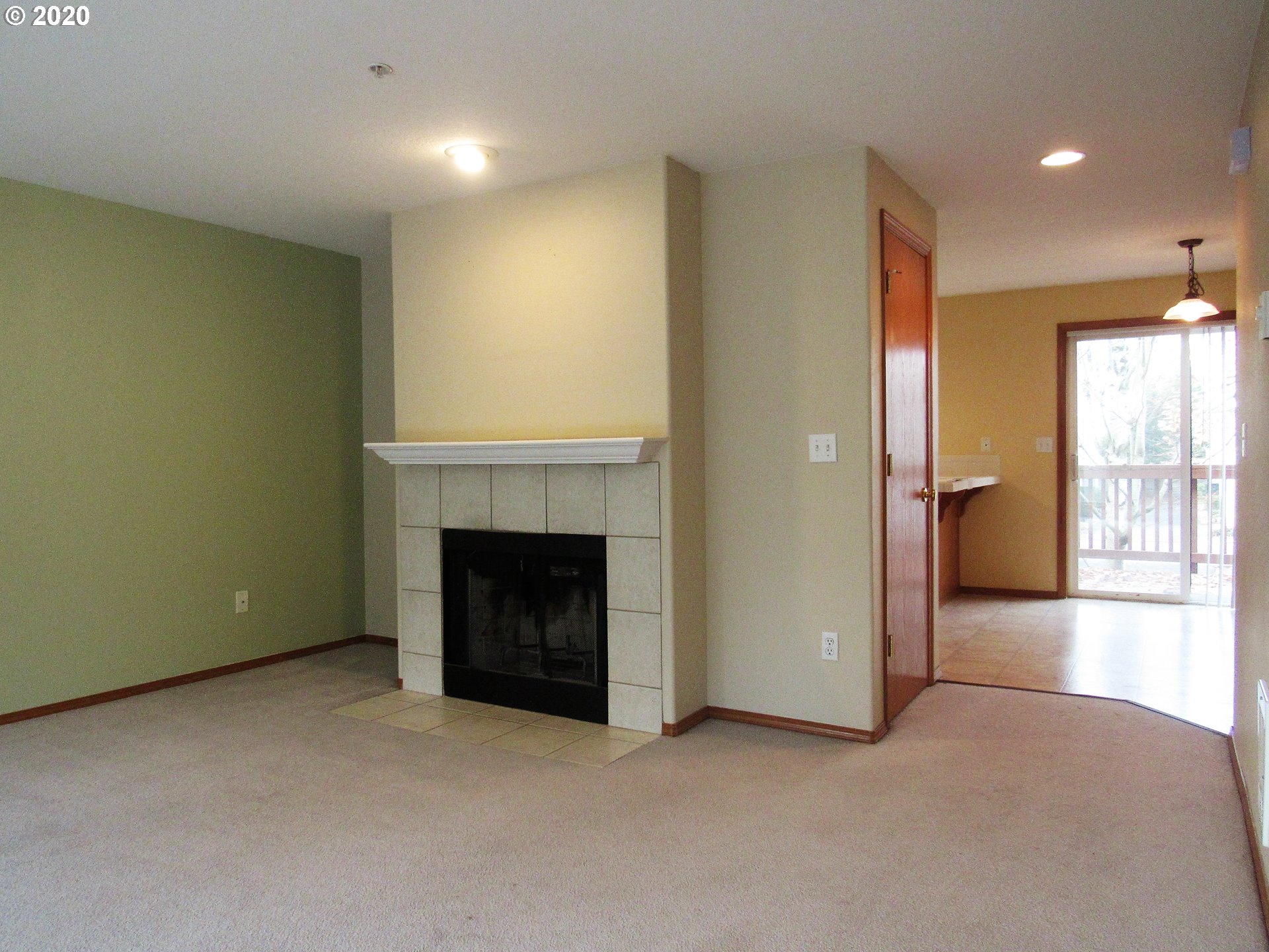 1244 Southwest 160th Avenue, Unit 101 Beaverton, OR 97006 - Photo 10 of 24 an empty room with fireplace and windows