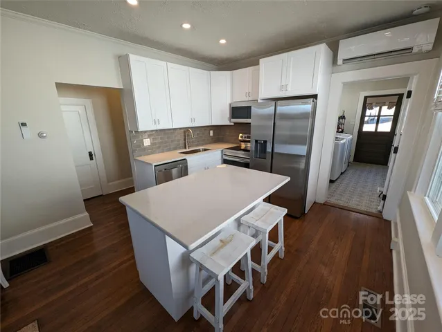 a view of a room with furniture wooden floor and windows