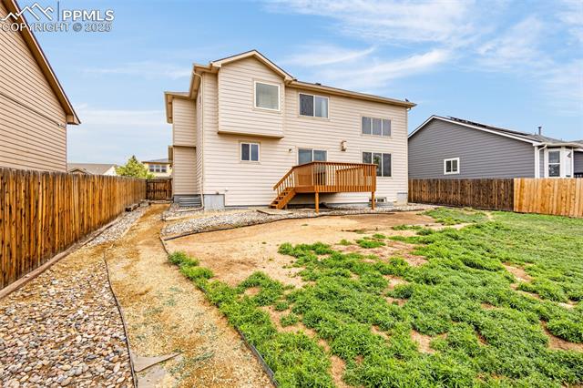 11045 Falling Star Road Fountain, CO 80817 - Photo 3 of 39 Rear view of property featuring a fenced backyard and a wooden deck