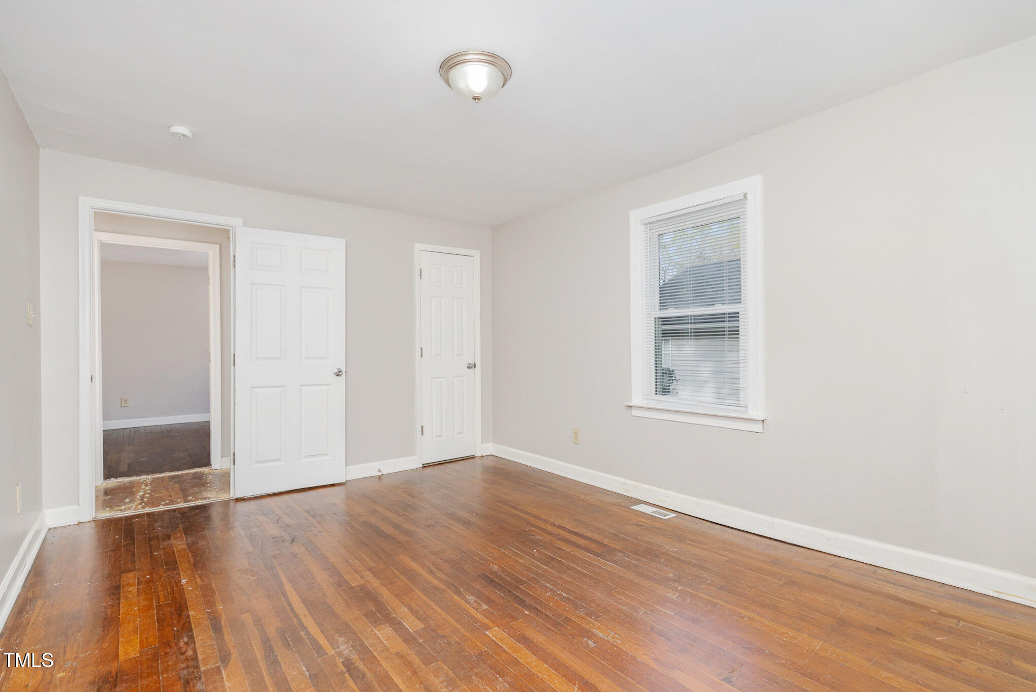 4505 Laymans Chapel Road Durham, NC 27704 - Photo 10 of 20 an empty room with wooden floor and windows