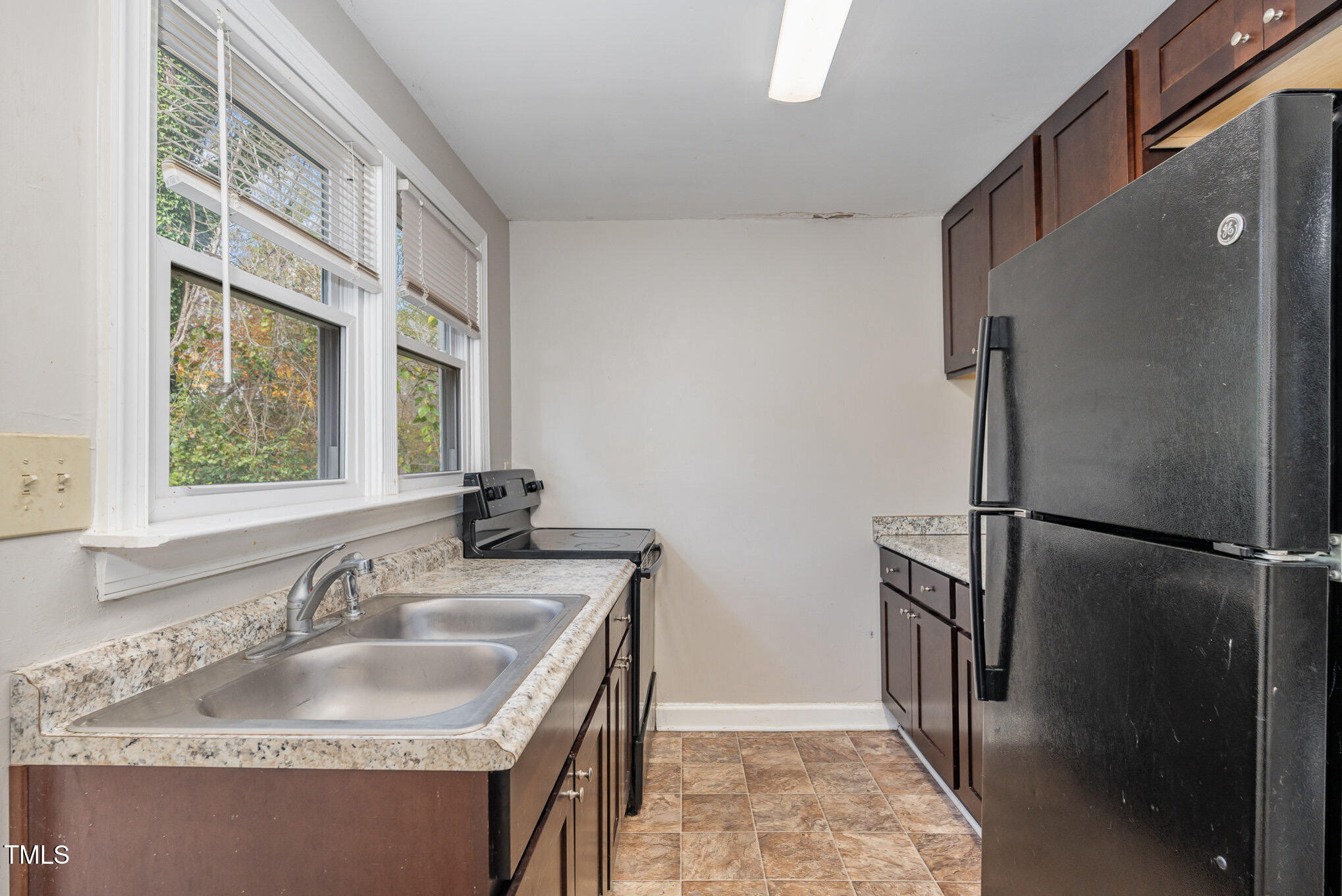 4505 Laymans Chapel Road Durham, NC 27704 - Photo 7 of 20 a kitchen with stainless steel appliances granite countertop a refrigerator and a sink