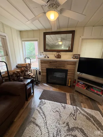 a living room with furniture a flat screen tv and a fireplace