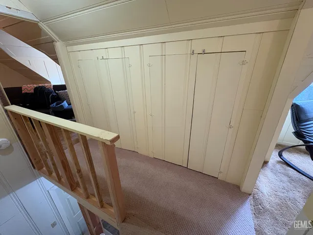 a bedroom with a bed and mirror