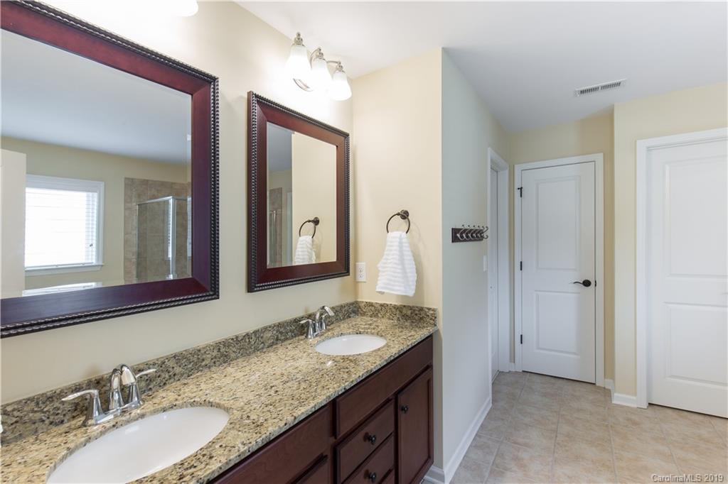 3347 Mandrake Court Tega Cay, SC 29708 - Photo 11 of 27 a bathroom with a granite countertop double vanity sink and a mirror