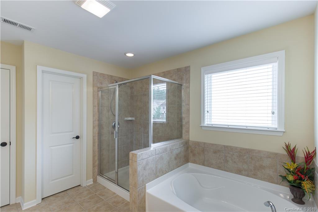 3347 Mandrake Court Tega Cay, SC 29708 - Photo 12 of 27 a bathroom with a bathtub and a shower