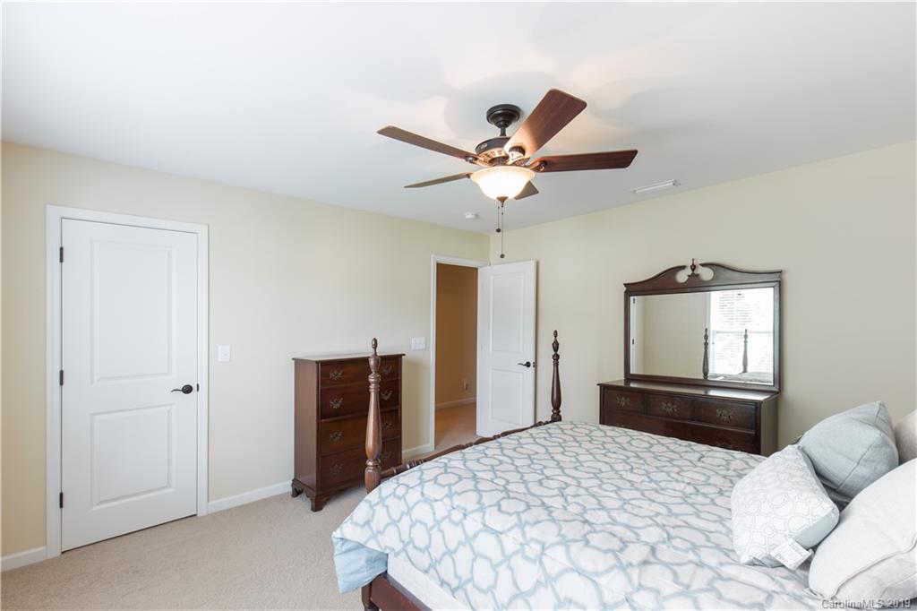 3347 Mandrake Court Tega Cay, SC 29708 - Photo 16 of 27 a bedroom with a bed and a chandelier