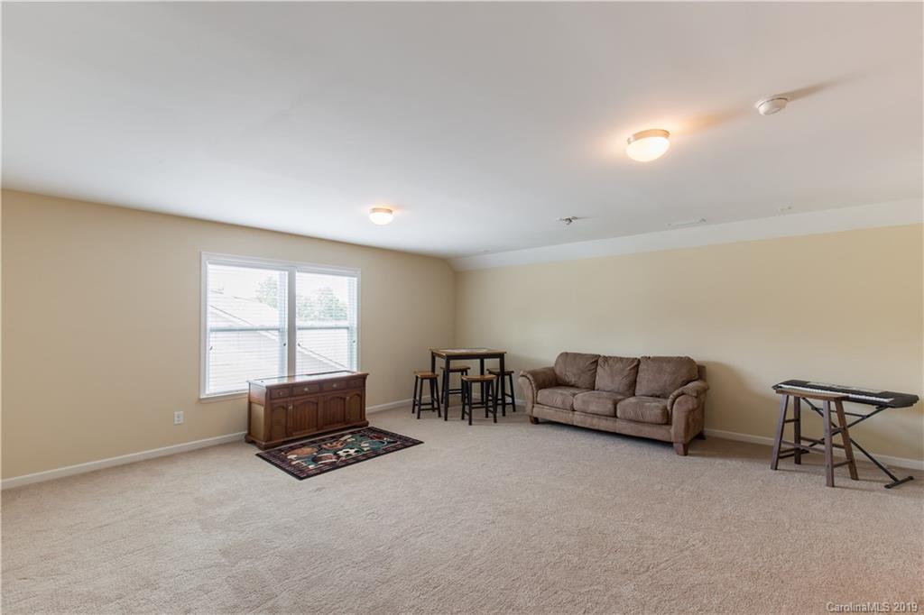 3347 Mandrake Court Tega Cay, SC 29708 - Photo 21 of 27 a living room with furniture and a window
