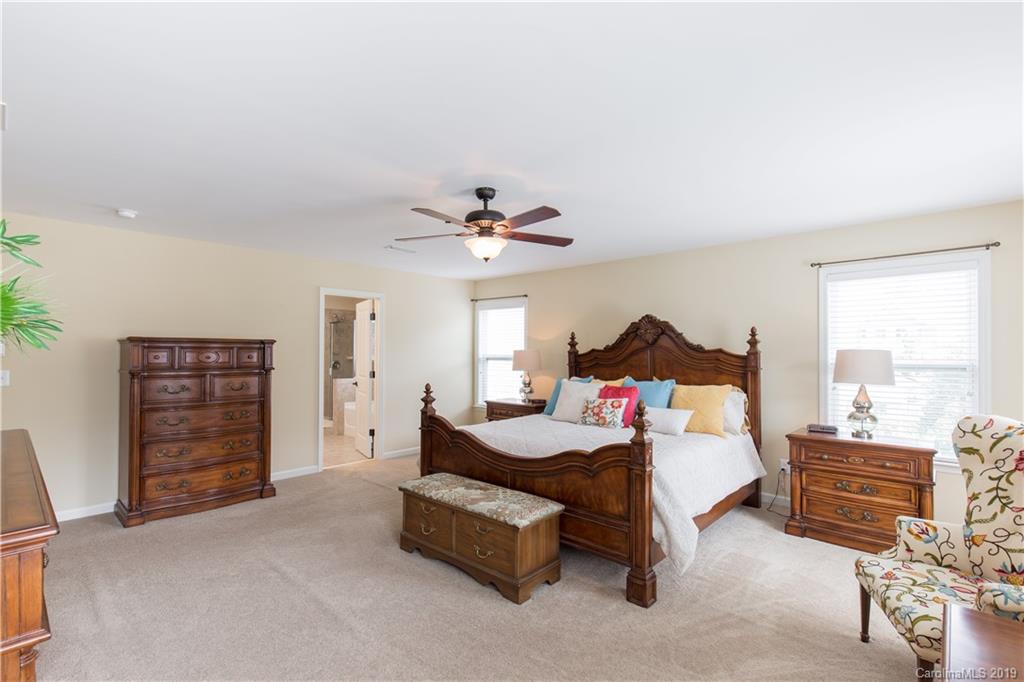 3347 Mandrake Court Tega Cay, SC 29708 - Photo 9 of 27 a bedroom with furniture and a chandelier