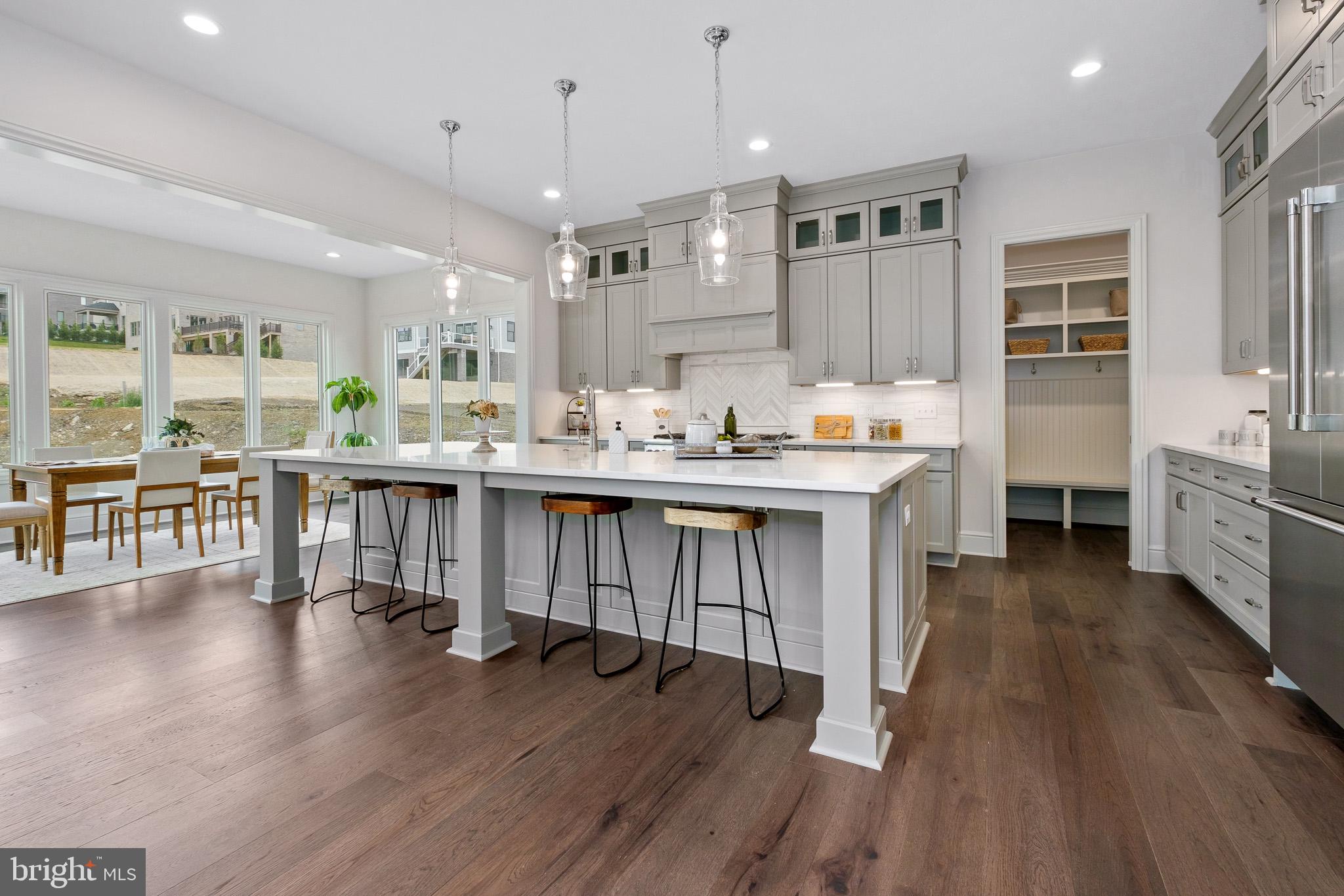 547 Webb Road Chadds Ford, PA 19317 - Photo 7 of 63 a open kitchen with stainless steel appliances granite countertop a stove a refrigerator a sink dishwasher and a dining table with wooden floor