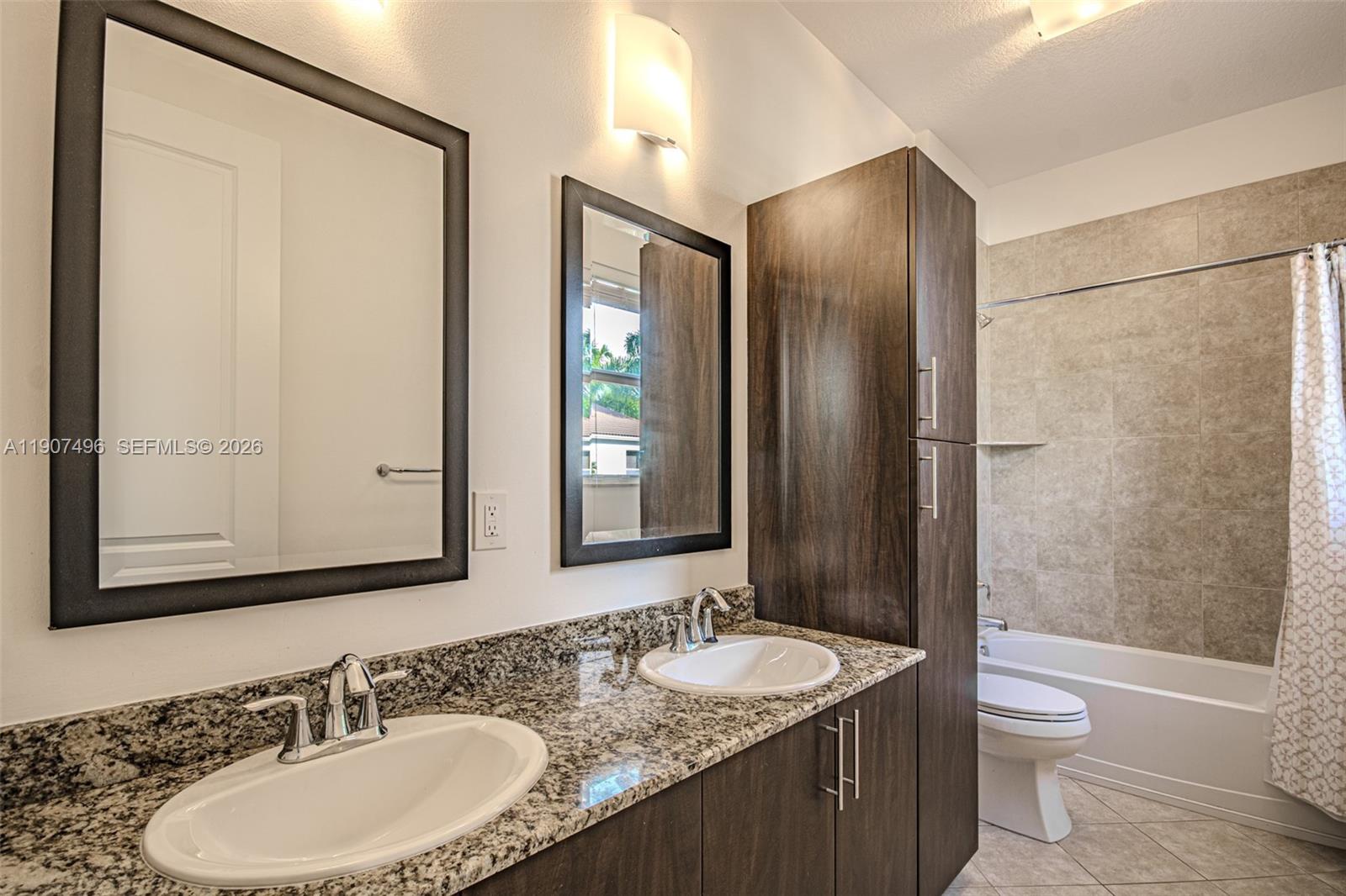 1430 Northwest 48th Drive Boca Raton, FL 33431 - Photo 20 of 33 a bathroom with a double vanity sink toilet mirror and shower