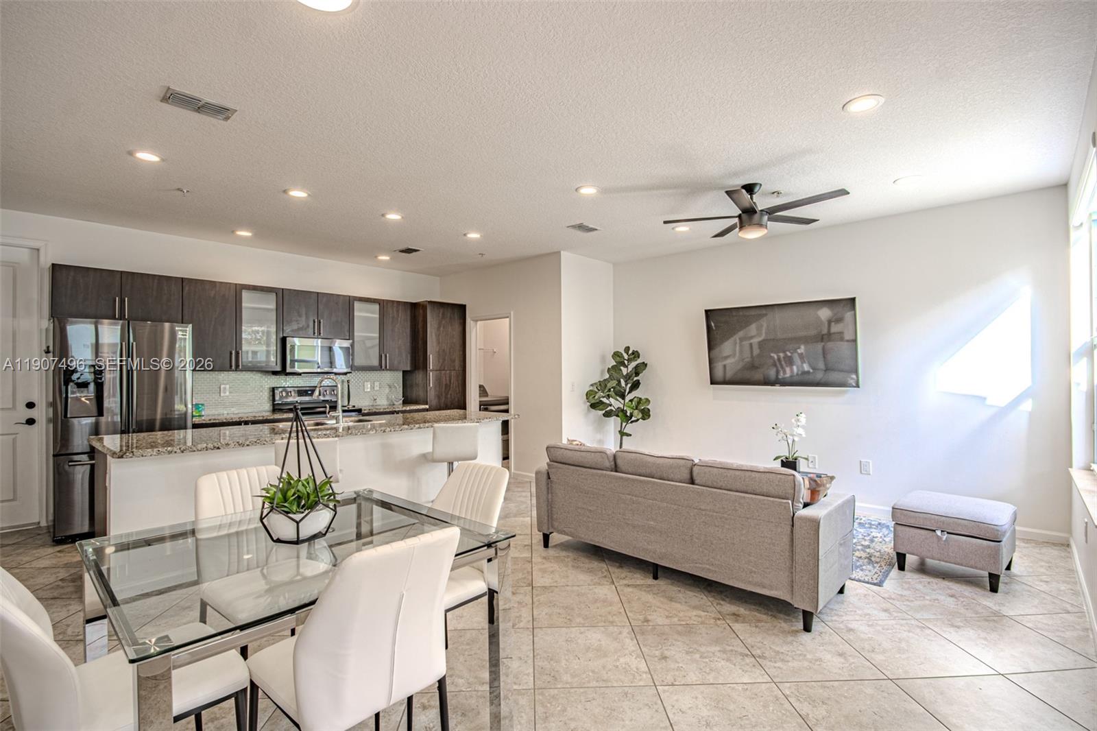 1430 Northwest 48th Drive Boca Raton, FL 33431 - Photo 5 of 33 a living room with furniture and a view of kitchen