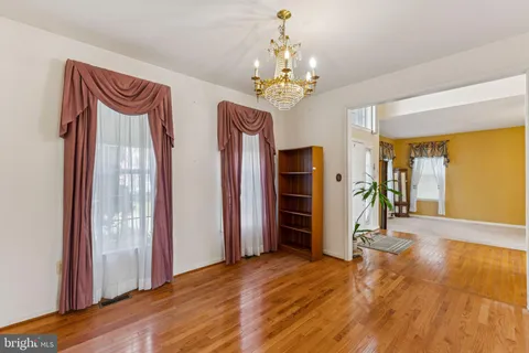 a view of an entryway with wooden floor and a livingroom