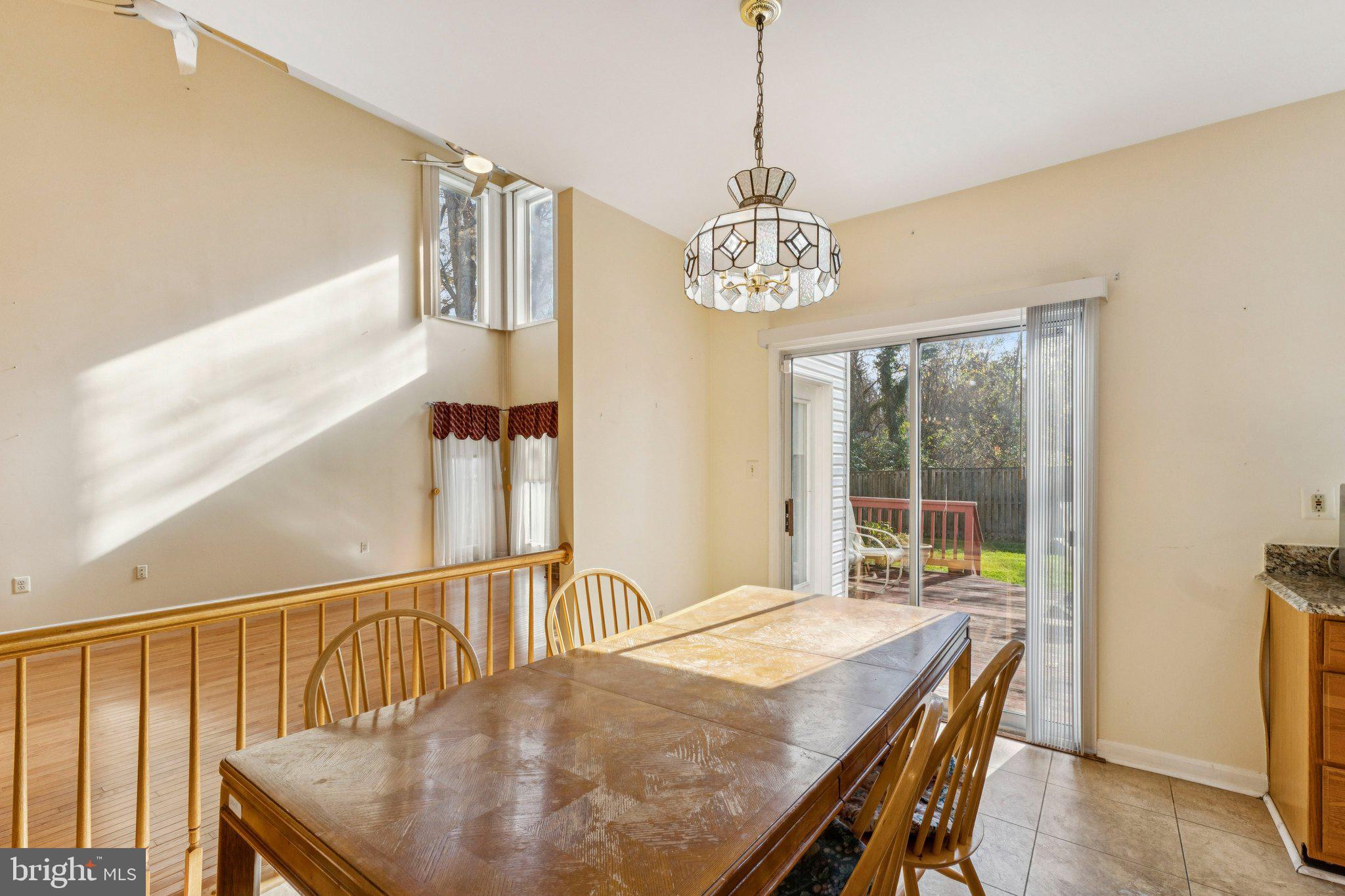 12205 Quick Fox Lane Bowie, MD 20720 - Photo 14 of 39 a view of a dining room with furniture window and wooden floor