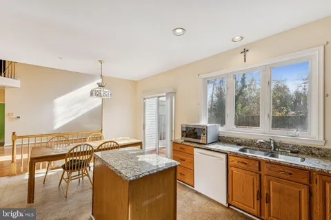 a kitchen with granite countertop a sink and a stove