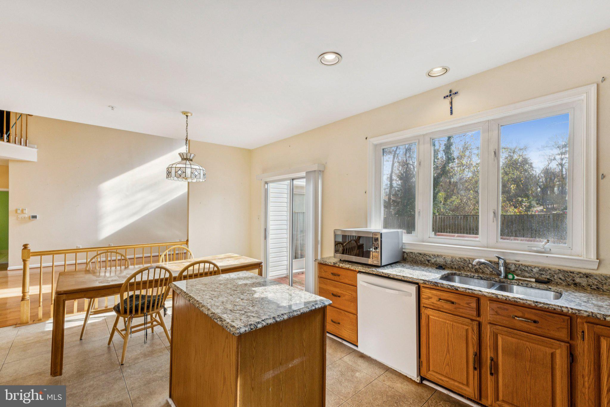 12205 Quick Fox Lane Bowie, MD 20720 - Photo 17 of 39 a kitchen with granite countertop a sink and a stove