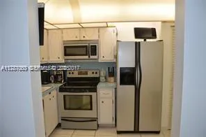 a kitchen with a stove microwave and refrigerator