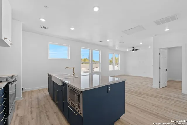 a kitchen with a sink stove and cabinets