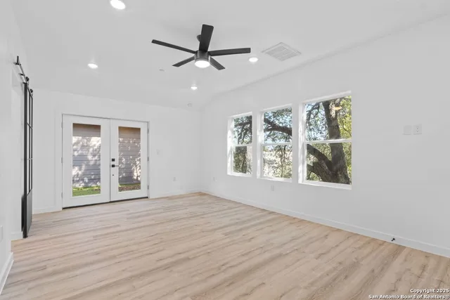 a bedroom with a large bed and a window