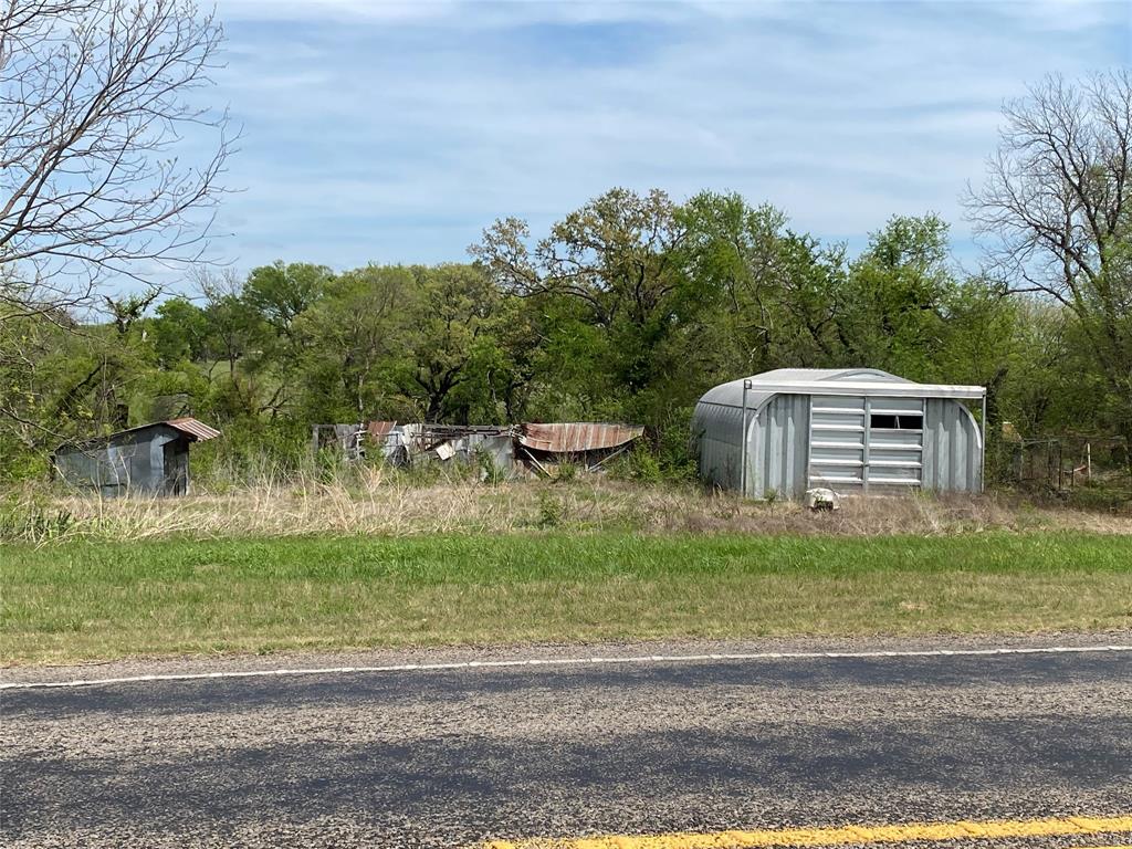 8929 West Fm 898 Ector, TX 75439 - Photo 8 of 12 a backyard of a house with lots of green space and trees