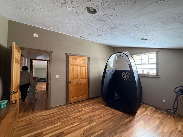 a bedroom with furniture and wooden floor