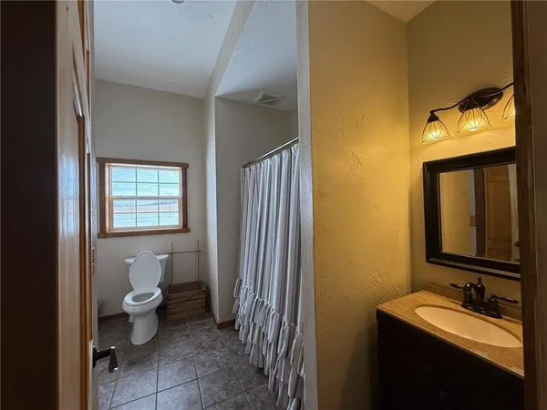 a bedroom with bed and a window