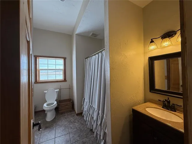 a bedroom with bed and a window