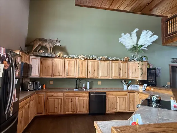 a kitchen that has a lot of cabinets a sink and a stove