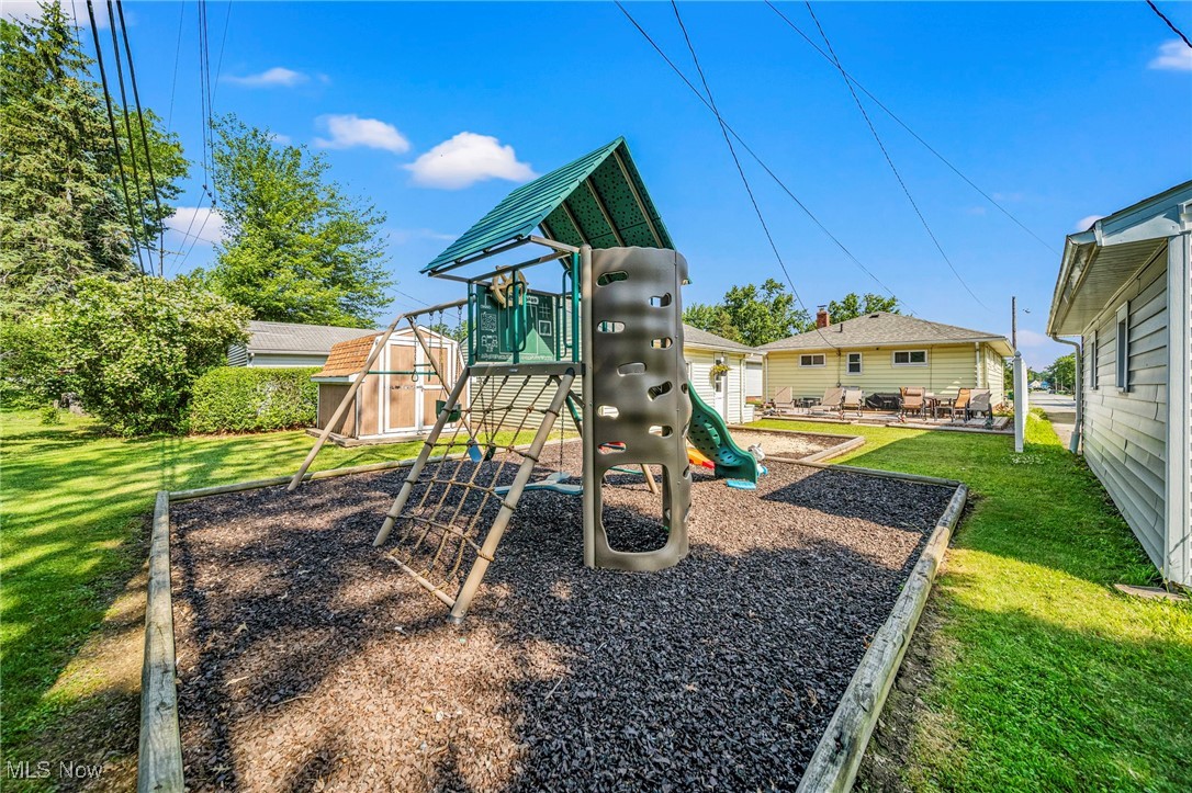28666 Forest Road Willowick, OH 44095 - Photo 27 of 27 View of playground with a yard and a shed