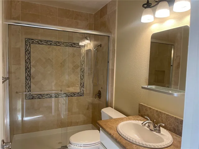 a bathroom with a toilet a sink and shower