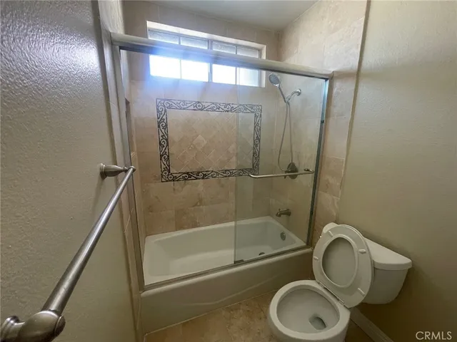 a bathroom with a shower a toilet and sink