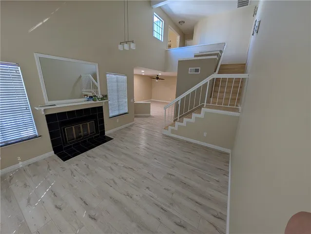 a view of a livingroom with wooden floor and a fireplace