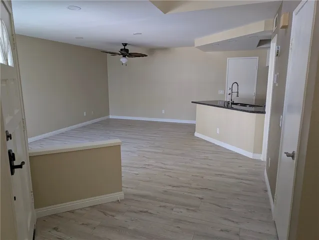 a room with wooden floor and white walls
