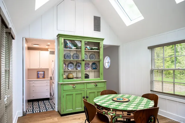 a dining room with furniture and a window