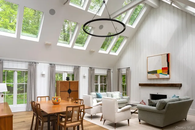 a living room with furniture a fireplace and a large window