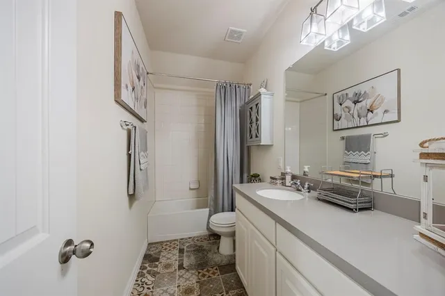 a bedroom with bed and a chandelier