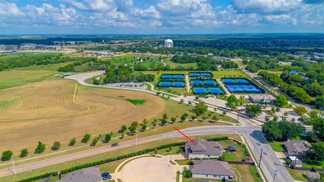 an aerial view of a golf course with a swimming pool