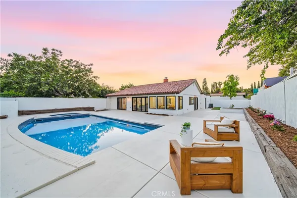 a balcony with furniture and a potted plant
