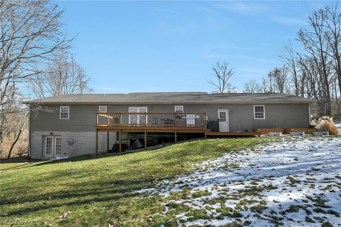 4900 Ellerman Road Zanesville, OH 43701 - Photo 25 of 28 Snow covered property featuring french doors, a lawn, and a deck