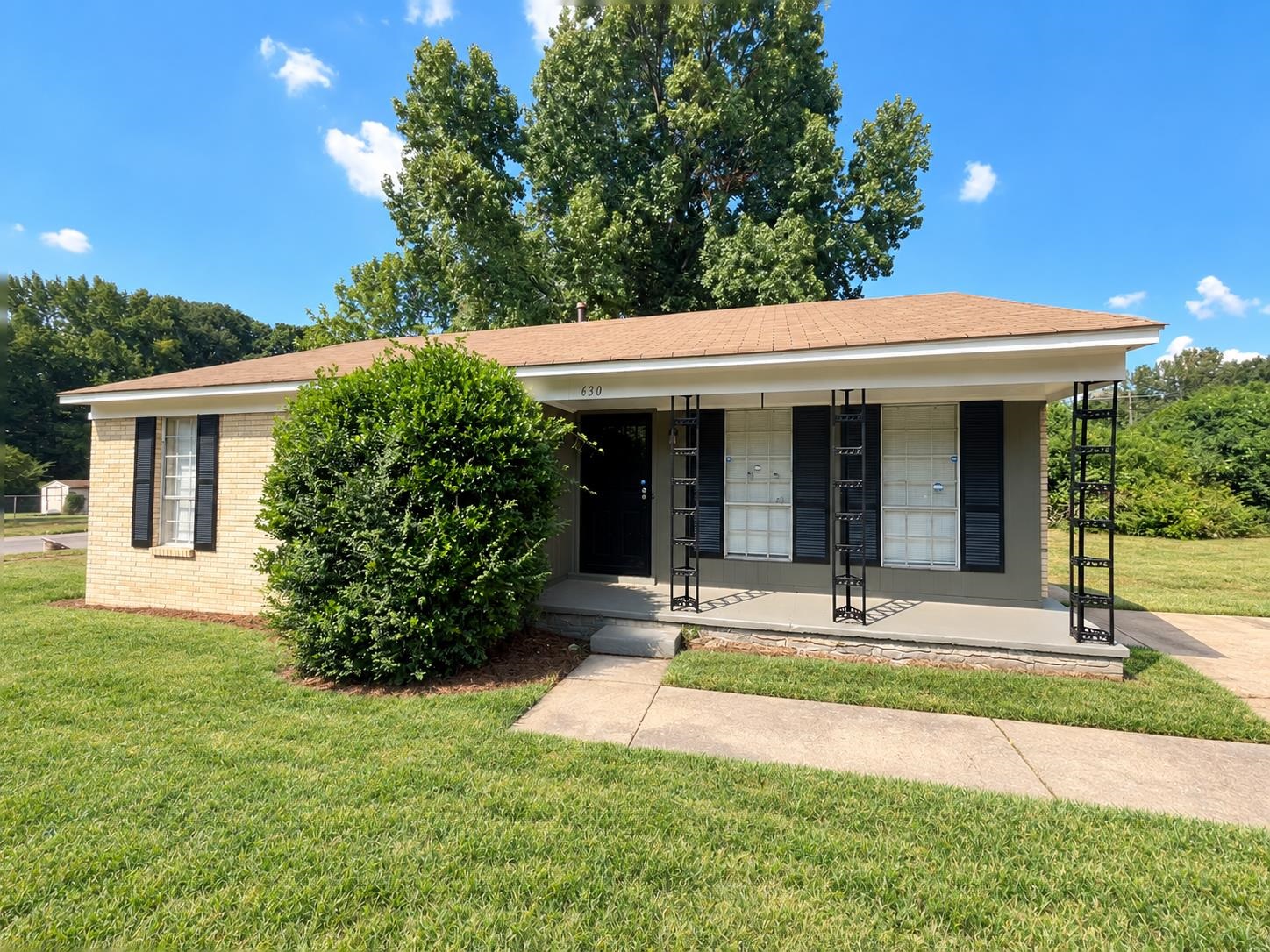630 Blackhawk Road Memphis, TN 38109 - Photo 1 of 14 Brick exterior with a covered porch, decorative metal porch supports, and a gabled roof