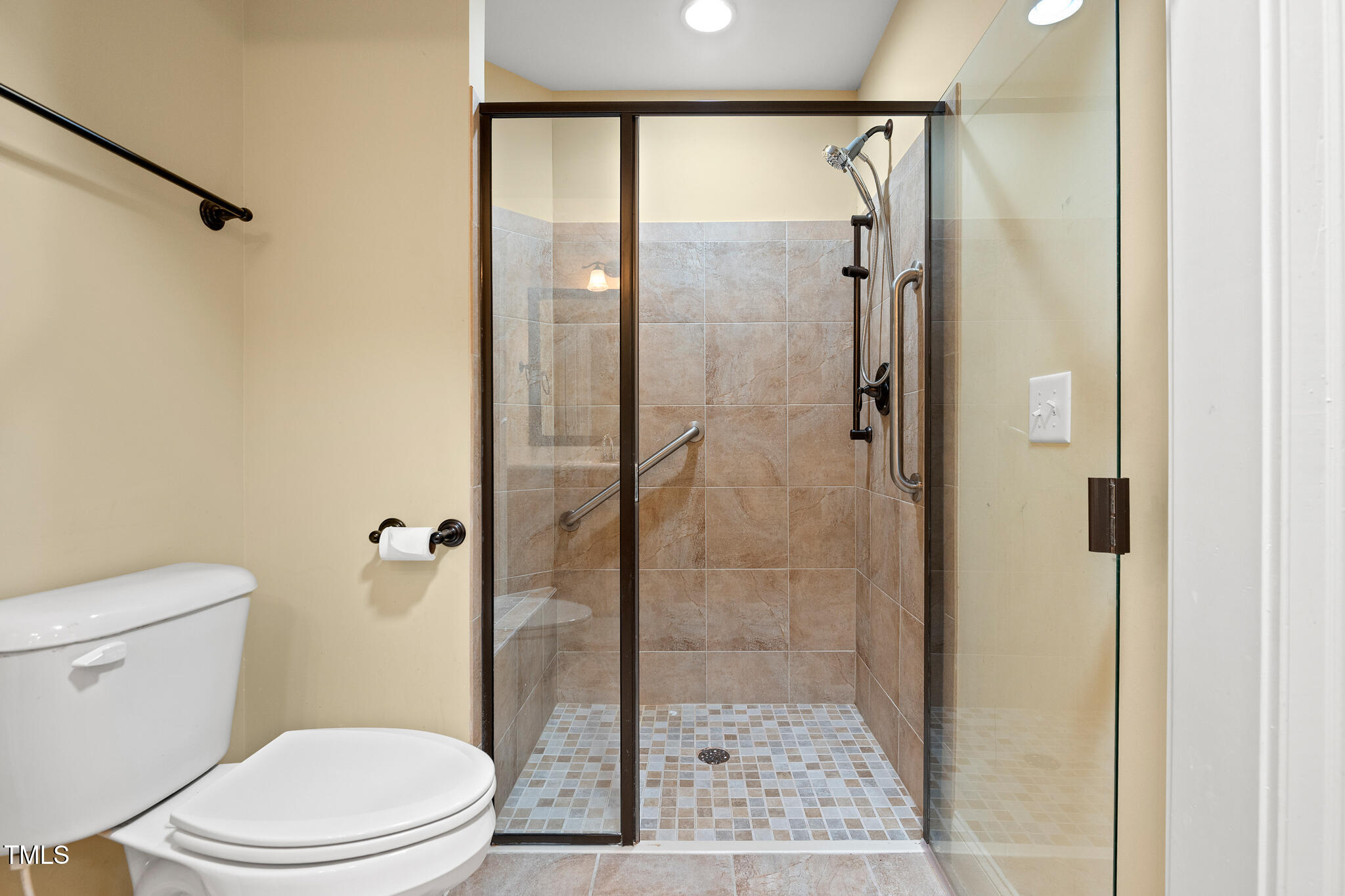 924 Carolina Bell Road Apex, NC 27502 - Photo 23 of 35 Curbless tiled shower with glass door and support rail