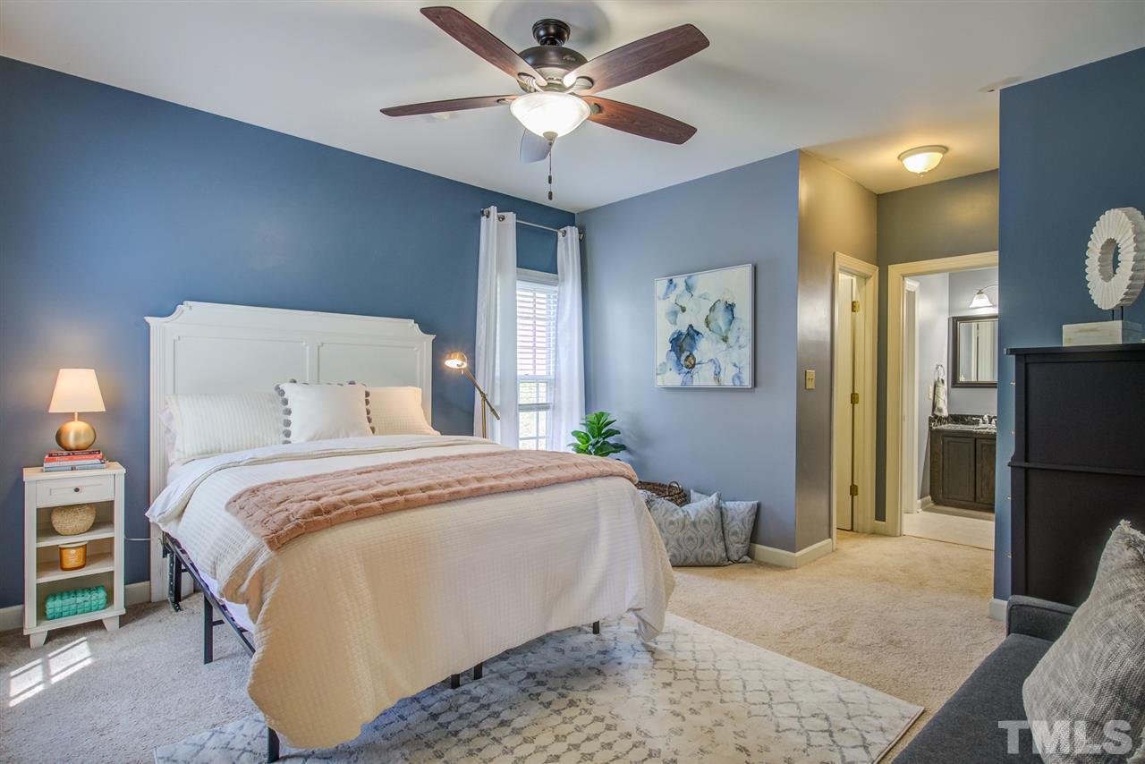 6908 Spring Drive Raleigh, NC 27613 - Photo 15 of 30 a bedroom with a bed and a television