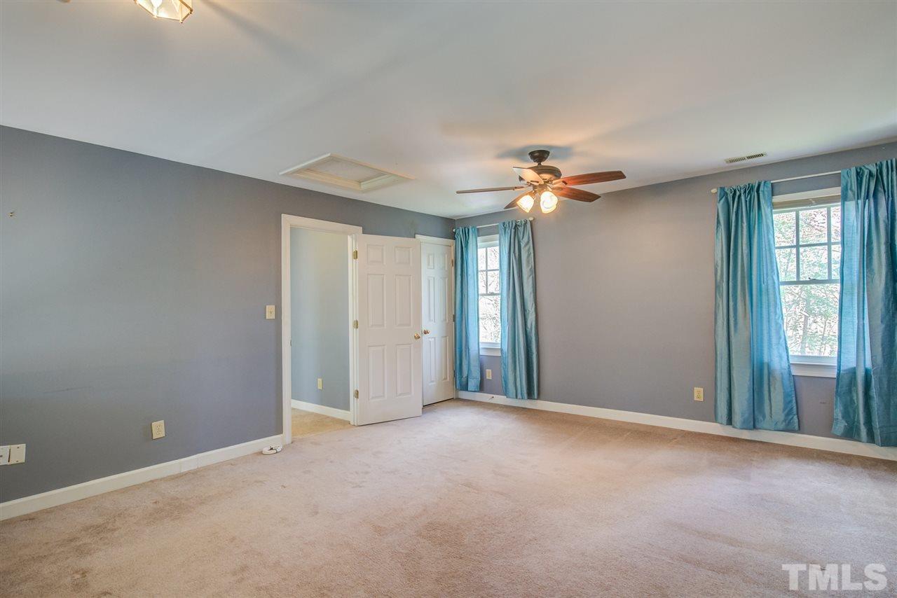 6908 Spring Drive Raleigh, NC 27613 - Photo 18 of 30 a view of a livingroom with a ceiling fan and window
