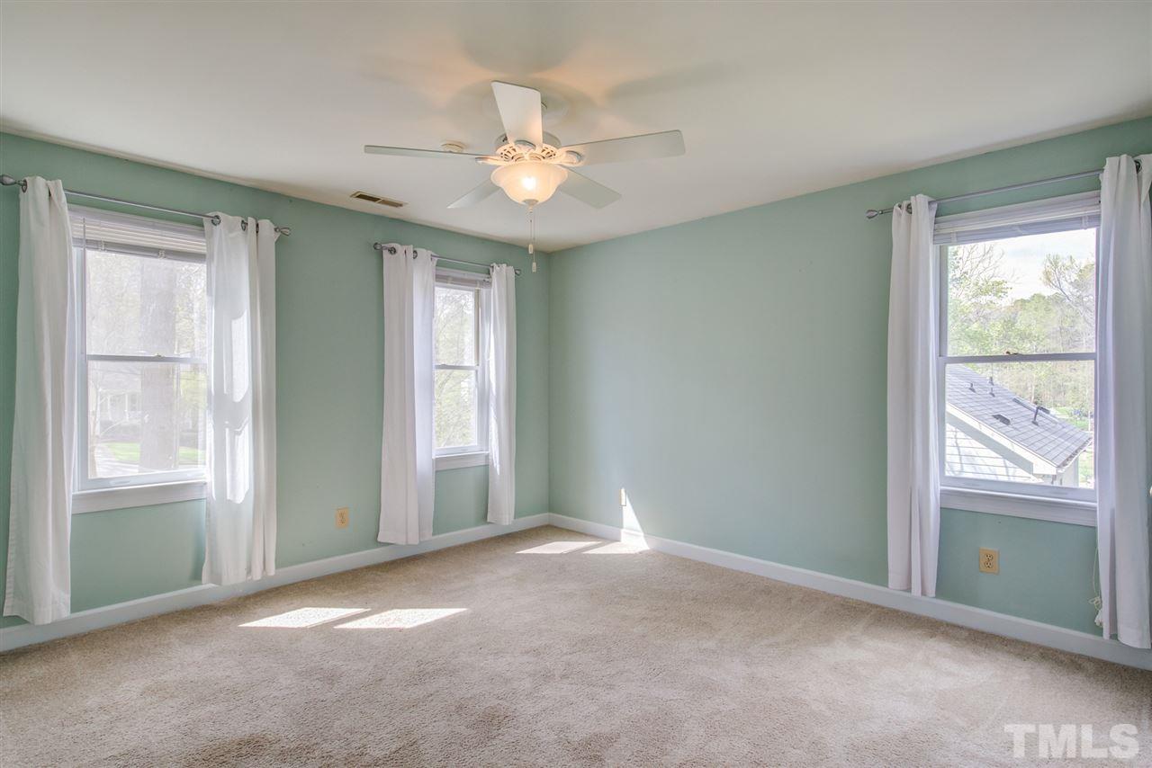 6908 Spring Drive Raleigh, NC 27613 - Photo 21 of 30 a view of an empty room with window and chandelier fan