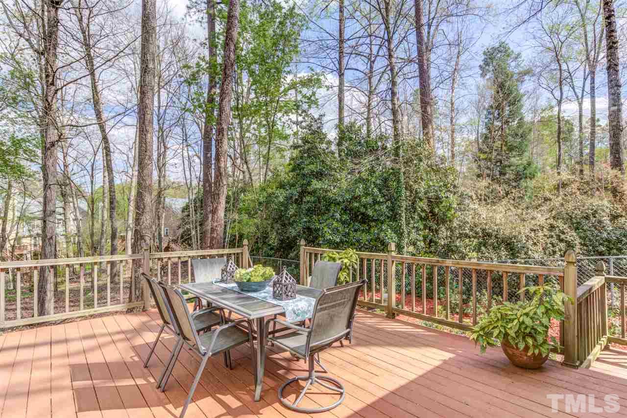 6908 Spring Drive Raleigh, NC 27613 - Photo 24 of 30 a view of a chair and table on the deck